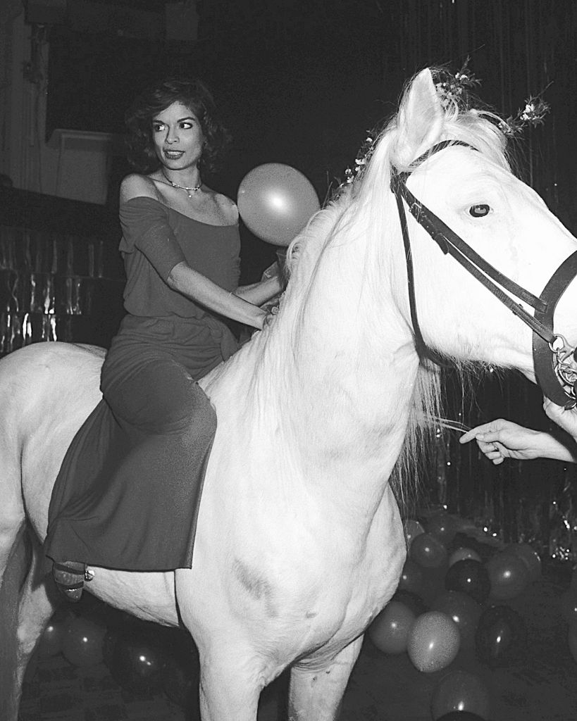 Bianca Jagger photographed on a white horse at Studio 54